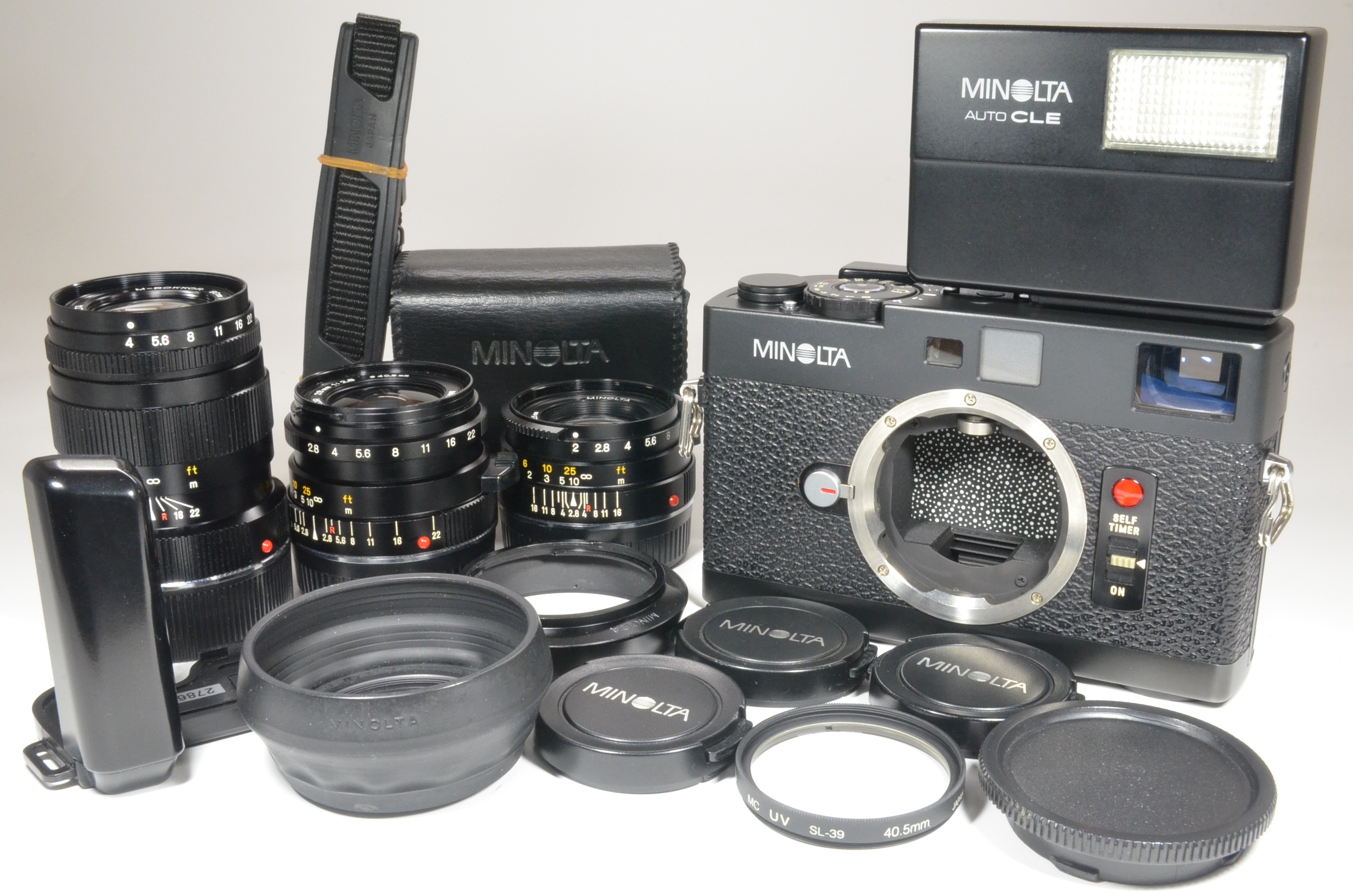 minolta cle film camera with m-rokkor 40mm, 28mm, 90mm, flash, strap and grip